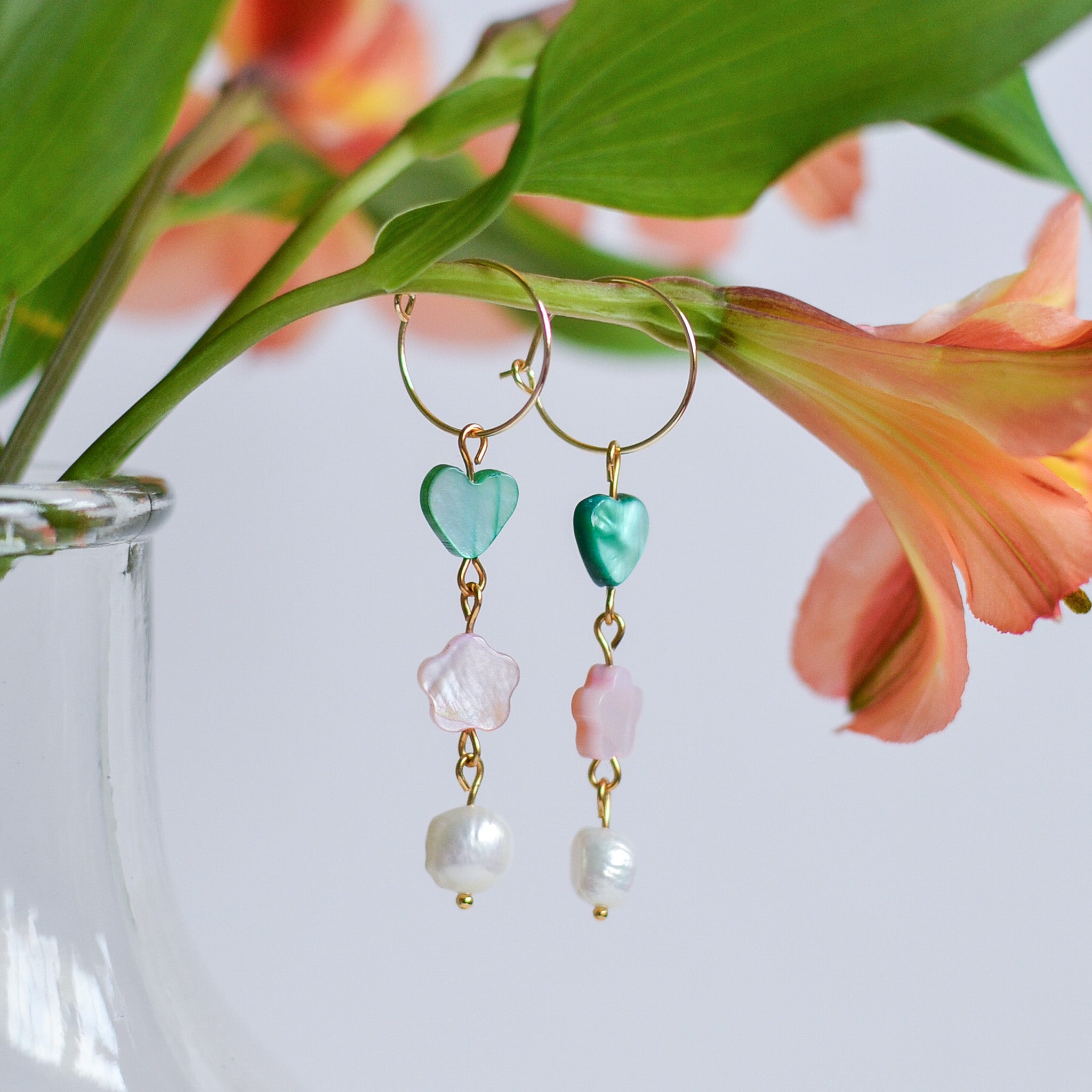 dangly hoop earrings, heart and flower beads, and freshwater pearls